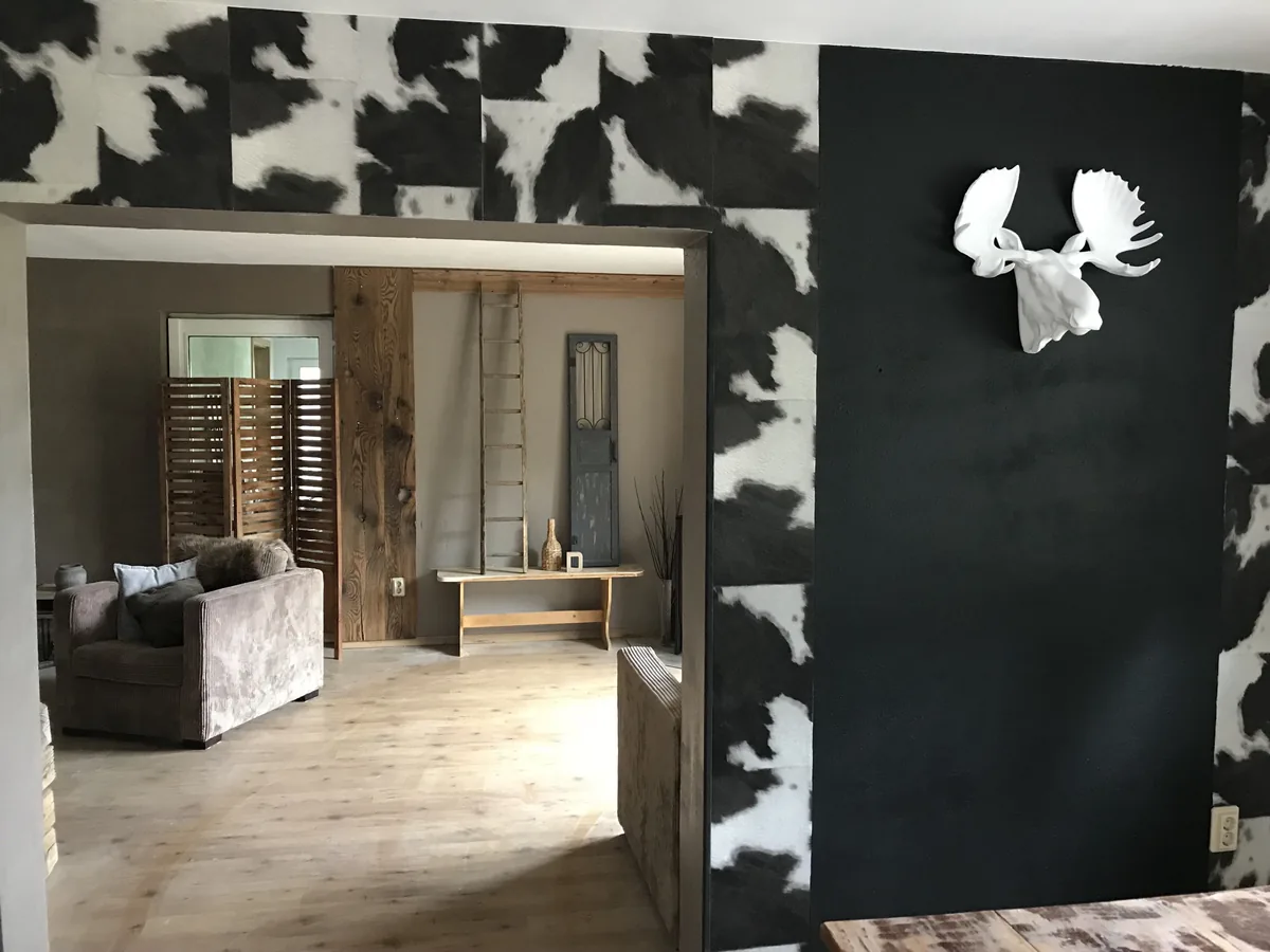 Woonkamer met een wand met koeienprint